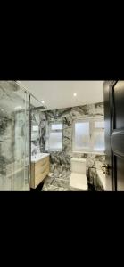 a bathroom with a shower and a toilet and a sink at 3 bedroom house Hildenborough in Hildenborough