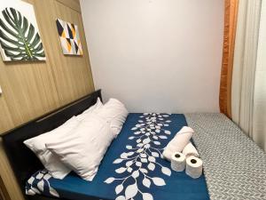 a bed with two towels and two pillows on it at Yam Staycation Shore Residences in Manila