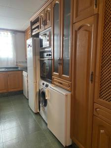 a kitchen with a refrigerator and a washer and dryer at Descans in Cullera