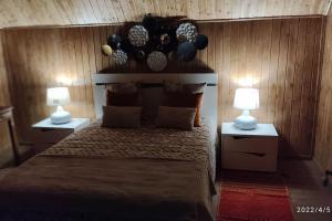 a bedroom with a large bed with two lamps at Casa do Neto. Anexo vale da Ginjeira. in Quinta da Carrapata