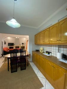 a kitchen with wooden cabinets and a table and chairs at Sitara's House in Karpenisi