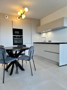 uma cozinha com mesa e cadeiras num quarto em Le Lily - T2 neuf vue mer em Èze