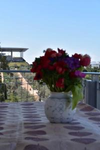 a vase filled with flowers sitting on a table at Stavros Niarhos apartment in Athens