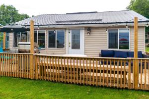 a wooden fence in front of a house at Stoneburg Cove Cottages in Carrying Place