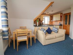a living room with a couch and a table at 5 Seymour Villas in Woolacombe