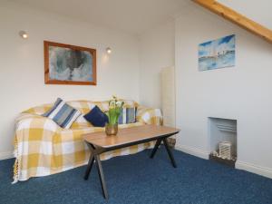a living room with a couch and a table at 5 Seymour Villas in Woolacombe