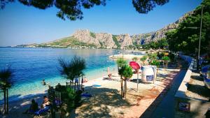 una vista di una spiaggia con persone in acqua di Apartment Sreta a Omiš (Almissa)