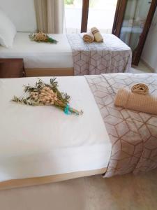 a group of three beds in a room at Villa Calypso in Skala Rachoniou