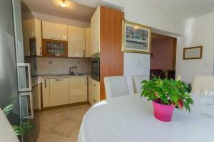 a kitchen with a table with a potted plant on it at Apartment Nikolina in Vinišće