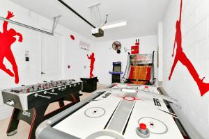 a room with a pool table and a diving machine at ONIP - Luxurious Elite Home with Theater Room near Disney by Rentyl - 7604W in Orlando