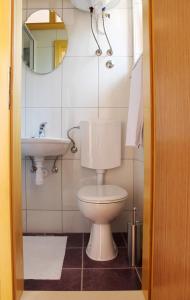 a bathroom with a toilet and a sink at Apartments Beautiful Sandy Beach in Split