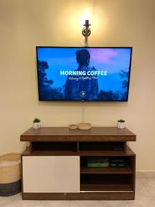 a flat screen tv sitting on top of a entertainment center at Cosy and spacious apartment in Meru in Meru