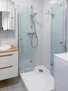 a bathroom with a shower with a glass door at Apartament Cudovny in Kudowa-Zdrój