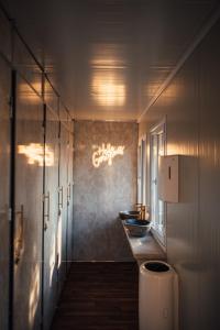 La salle de bains est pourvue de 2 lavabos et d'un lustre. dans l'établissement Glamping Blessed Aquabest, à Best
