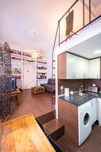a kitchen and living room with a washer and dryer at Singular apartamento en Delicias by beBalmy in Madrid