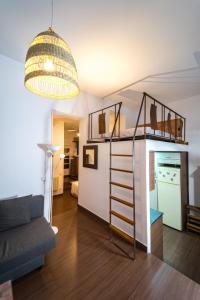 a room with a loft bed and a living room at Singular apartamento en Delicias by beBalmy in Madrid