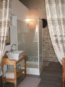 a bathroom with a shower and a sink and a tub at La Maison Salée in LʼAiguillon-sur-Mer