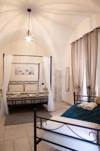 two beds in a room with curtains at Dimora Guerrieri in Brindisi