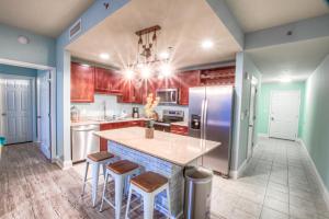 een keuken met een groot eiland met barkrukken bij Laketown Wharf 429 By Aneliya in Panama City Beach