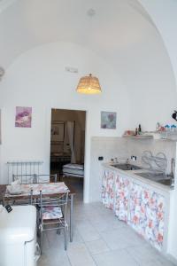 a kitchen with a table and a counter top at Dimora Guerrieri in Brindisi