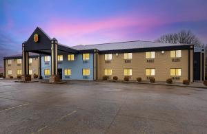 a large building with a parking lot in front of it at Super 8 by Wyndham Eddyville/Kuttawa in Eddyville