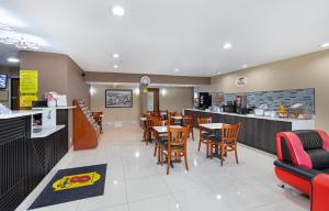 a restaurant with tables and chairs and a counter at Super 8 by Wyndham Eddyville/Kuttawa in Eddyville
