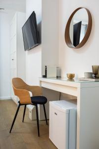 a room with a desk with a chair and a mirror at Finn Luxury Suites in Split