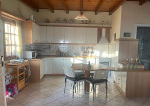 a kitchen with a table and chairs in it at pines & sea in Sofiko