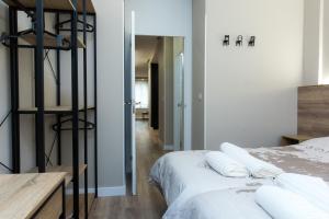 a bedroom with a bed with white pillows on it at Apartamento BOSTON - Centro, Nuevo, Confort, Wifi in Valladolid