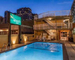 a pool at a quality inn with a hotel sign at Quality Inn Sacramento in Sacramento