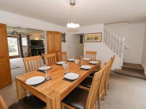 a dining room with a wooden table and chairs at Shatterford Lakes in Bewdley