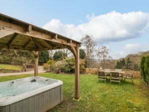 a hot tub in a yard with a gazebo at Shatterford Lakes in Bewdley