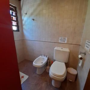 a bathroom with a toilet and a sink at Increíble casa a 4 cuadras del mar in Mar del Plata