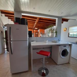 a kitchen with a refrigerator and a washing machine at Increíble casa a 4 cuadras del mar in Mar del Plata