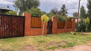 a fence with a small tree in a yard at BanTelmo in Juana Koslay 
