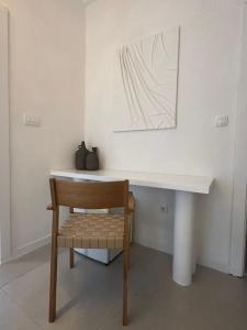 a desk with a chair and a painting on the wall at Villa Vele in Herceg-Novi