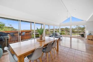 a dining room with a wooden table and chairs at Happy Place of Light and Water Views in Jan Juc in Torquay