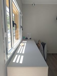 a large white table in a room with a window at Departamentos pura vida 2 in General Roca