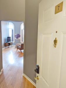 a room with a white door and a living room at Tanner Building in Bay City