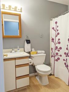 a bathroom with a toilet and a sink and a mirror at Tanner Building in Bay City +163 photos