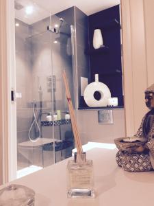 a bathroom with a glass shower stall and a statue on a counter at Luxury Apartment North Greenwich London in London