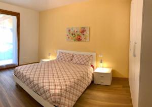 a bedroom with a bed and two night stands at Casa di Nancy Girasole a Valdobbiadene Unesco in Valdobbiadene