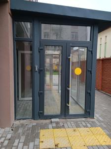 an open door of a building with glass at Apartments Domovik Миру 11с /11 in Mukacheve