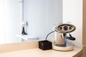 a toaster sitting on a counter in front of a mirror at Lovely Studio with a big terrace in Belgrade