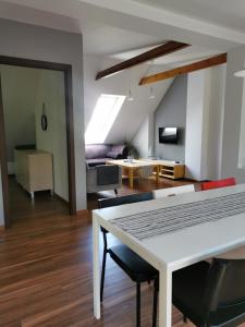 a living room with a white table and chairs at Przy Przystani in Stegna