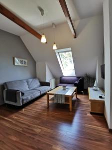 a living room with a couch and a table at Przy Przystani in Stegna