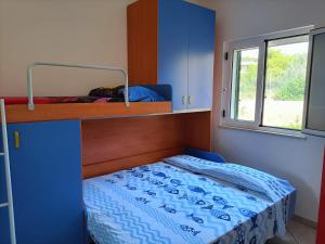 a bedroom with a blue bunk bed and a window at Terrazza Del Salento in Santa Cesarea Terme