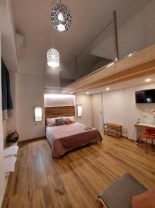 a large bedroom with a bed and a desk at Core Cagliari in Cagliari