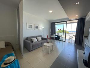 a living room with a couch and a table at RentOnTheBeach Studio 2 in Los Cristianos