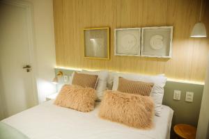 a bedroom with a white bed with two pillows at Apartamento Beira Mar com Jacuzzi in João Pessoa +67 photos